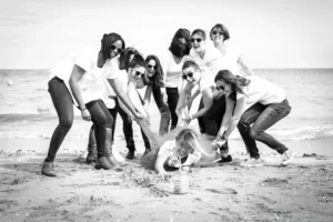 Photo de groupe amusante avec la future mariée au centre sur la plage de Cabourg.
