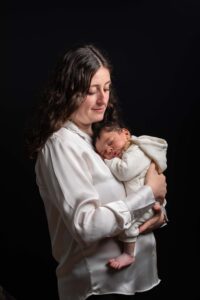 Portrait doux d'une jeune maman berçant son bébé contre elle, shooting photo Honfleur.